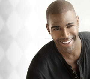 Headshot of a smiling adult male model in a black shirt