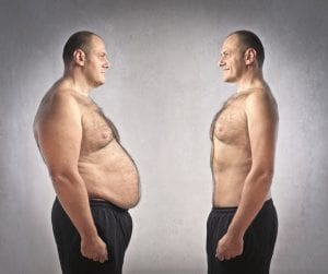 Man who lost weight looking at his former self