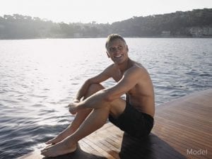 man sitting by the lake