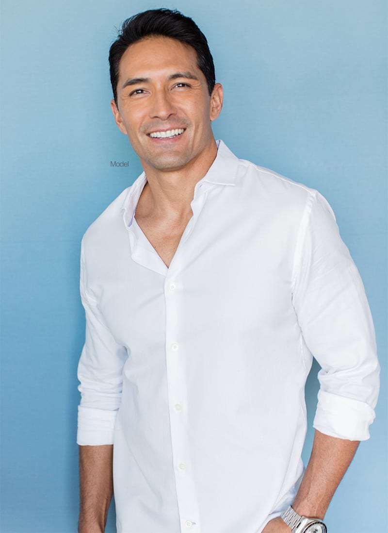 Adult male model smiling in a white button up shirt