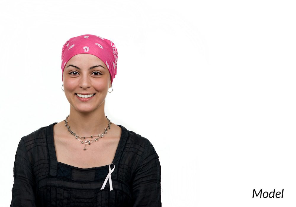 Woman celebrating the end of her breast cancer treatment.