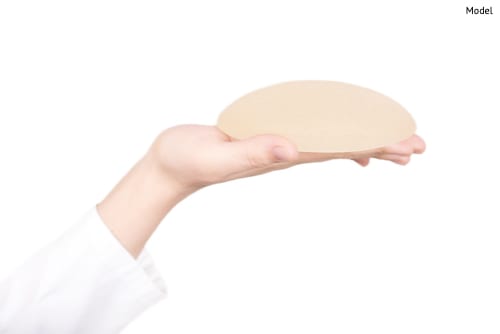 Close up of hand holding silicon breast implant